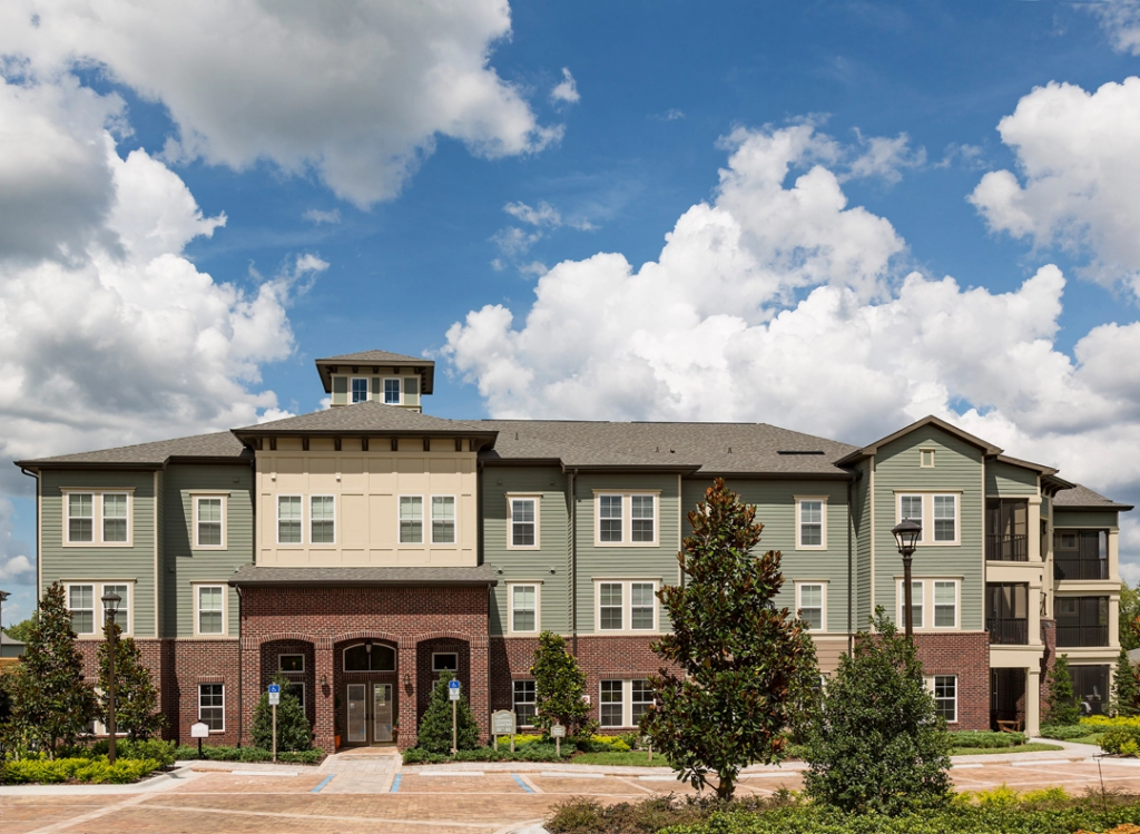 Parking lot with residential buildings and leasing office entrance