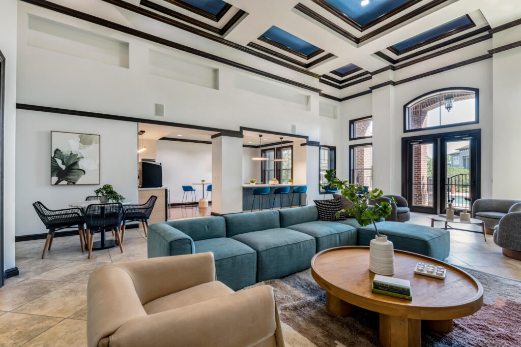 Clubhouse interior with tile flooring, couch and lounge seating, and natural lighting