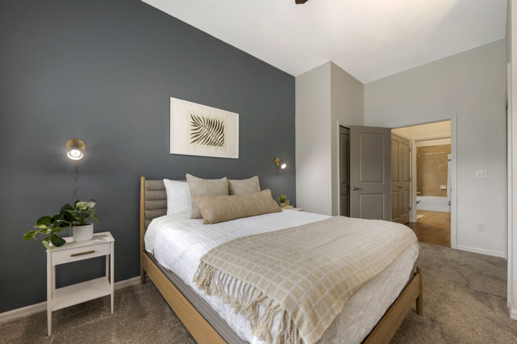 Bedroom with carpet flooring and blue accent wall